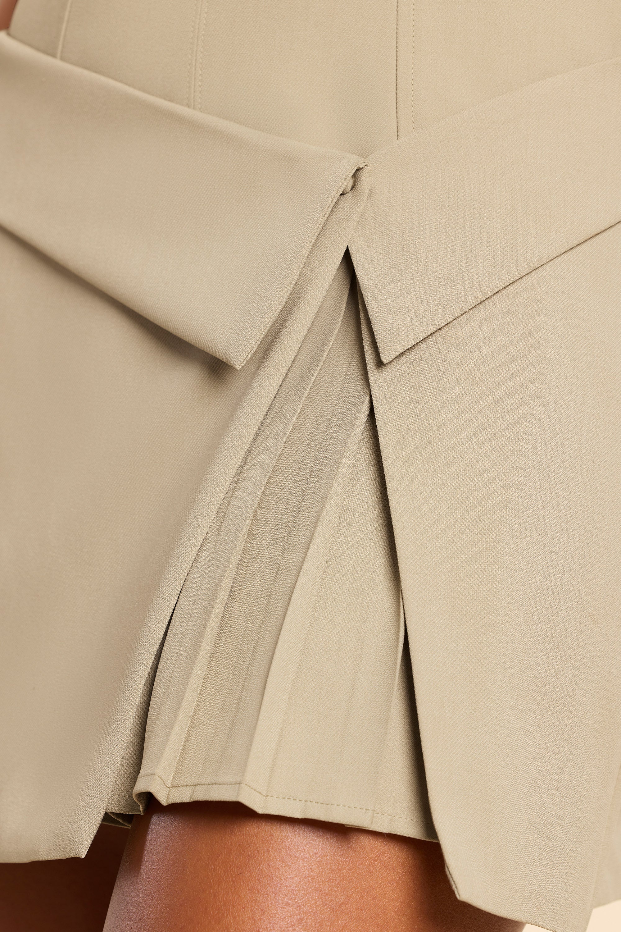 Bruna-Woven Twill Wrap Over Pleated Mini Dress in Taupe